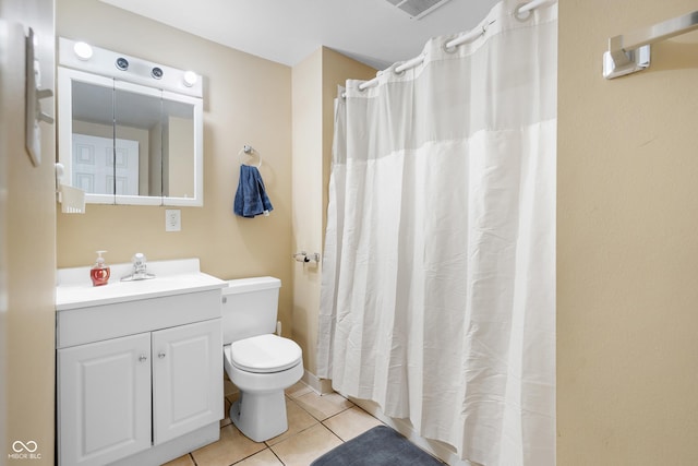 bathroom featuring tile patterned floors, vanity, and toilet