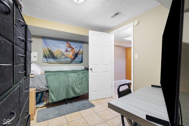 bathroom with tile patterned floors and a textured ceiling