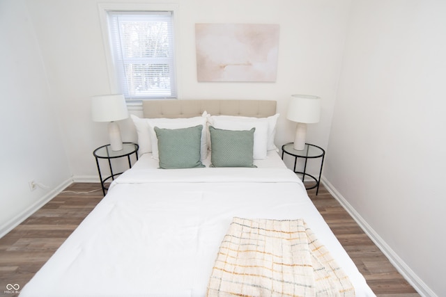 bedroom with hardwood / wood-style flooring