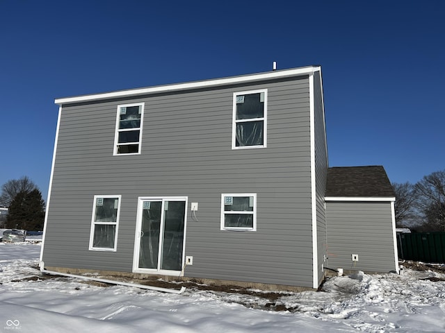 view of snow covered rear of property