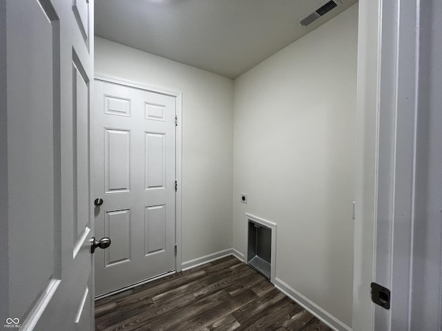 laundry room with laundry area, hookup for an electric dryer, visible vents, and dark wood-style flooring