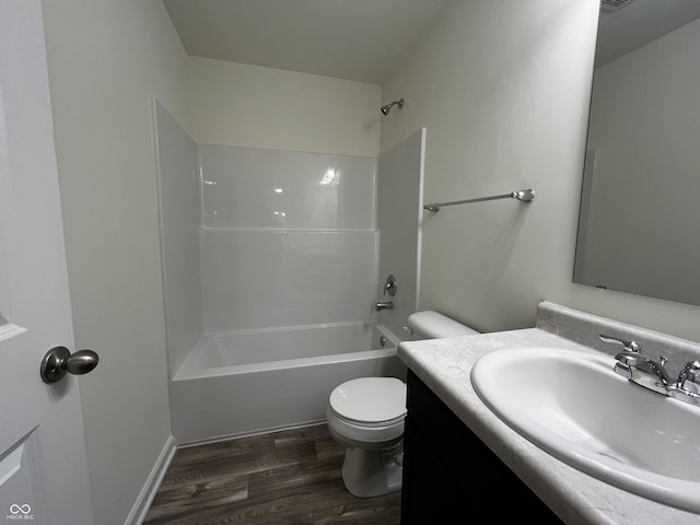 full bathroom with toilet,  shower combination, wood finished floors, and vanity