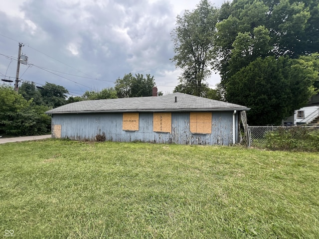 view of side of home featuring a lawn