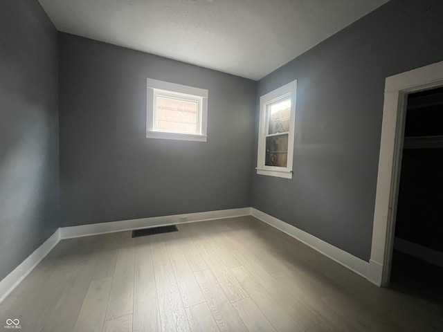 unfurnished room featuring hardwood / wood-style floors