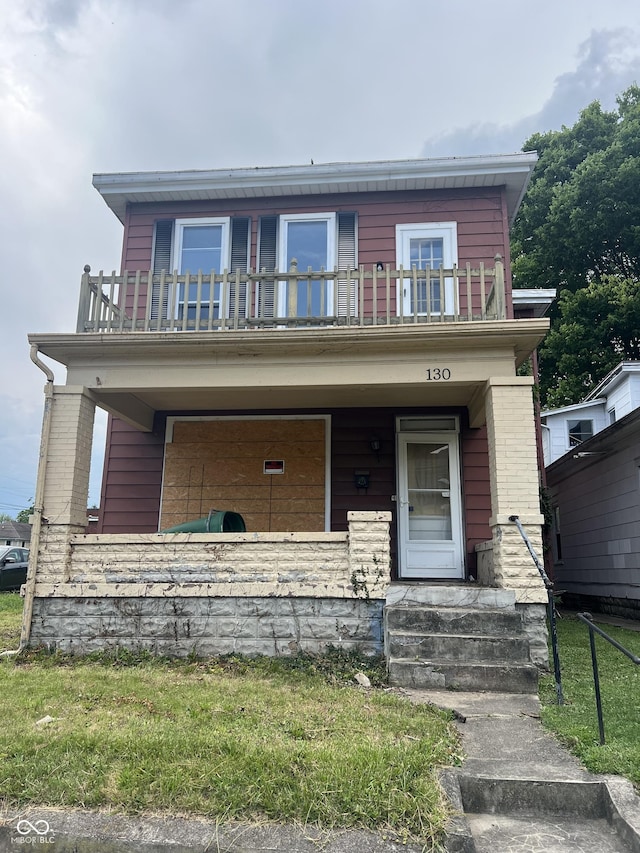 view of front of home with a balcony and a porch