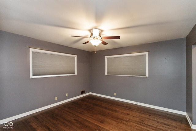 unfurnished room featuring dark wood-type flooring and ceiling fan