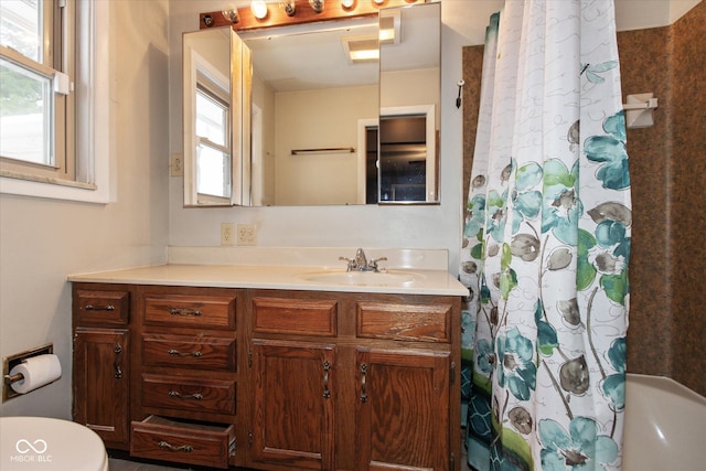 full bathroom featuring vanity, shower / tub combo, and toilet