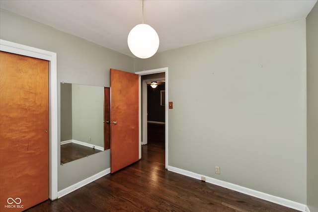 unfurnished bedroom featuring dark hardwood / wood-style floors