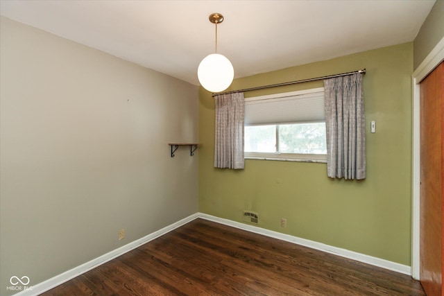 empty room with dark wood-type flooring