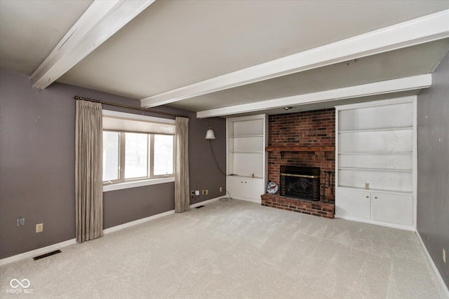 unfurnished living room with a brick fireplace, light colored carpet, and beam ceiling