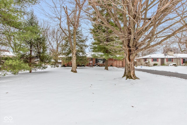 view of yard layered in snow