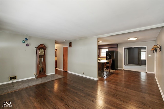 unfurnished living room featuring dark wood-type flooring