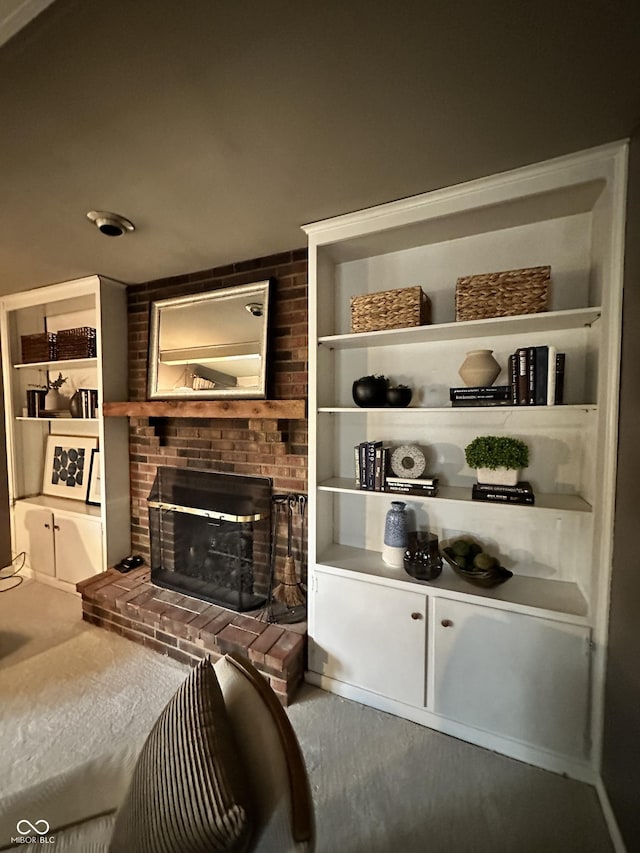 interior space with a brick fireplace and hardwood / wood-style flooring