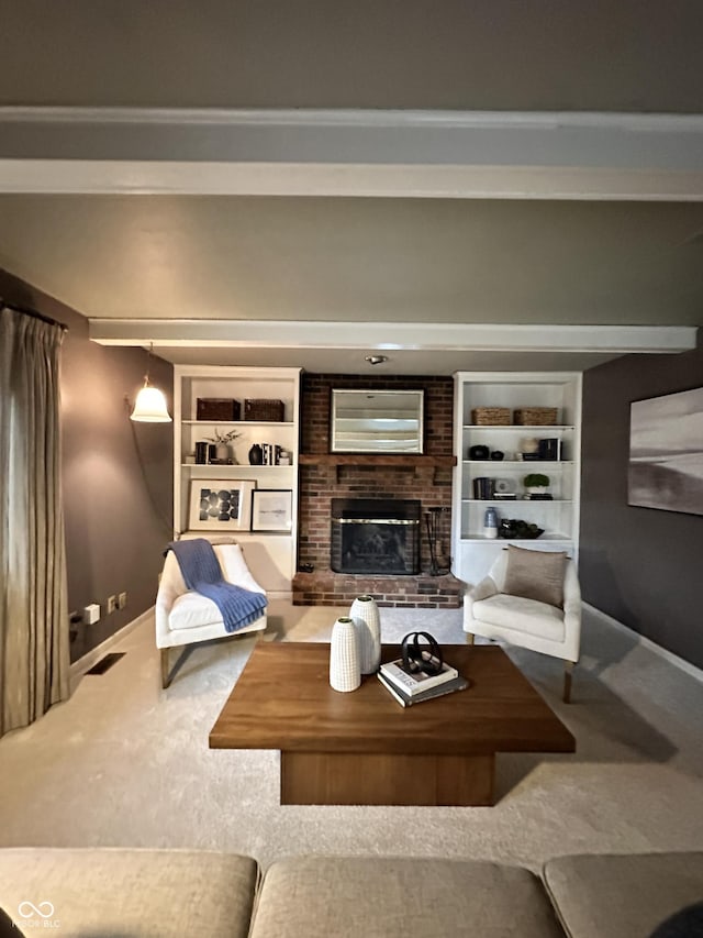 living room with a brick fireplace, built in shelves, and carpet floors