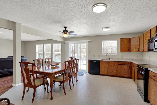 dining space featuring sink, ceiling fan, and light tile patterned flooring