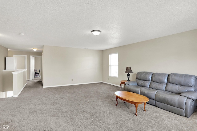 carpeted living room featuring a textured ceiling