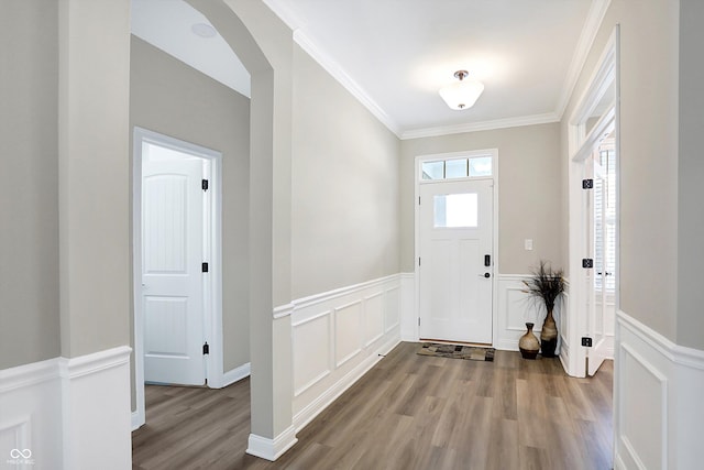 entrance foyer with wood-type flooring and crown molding