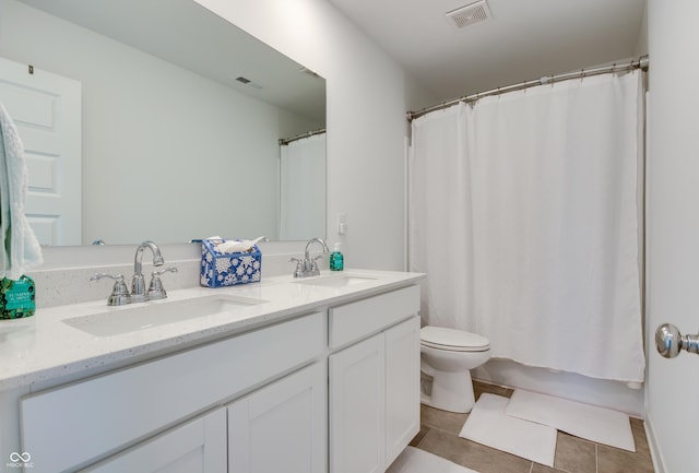 full bathroom featuring tile patterned floors, vanity, toilet, and shower / tub combo