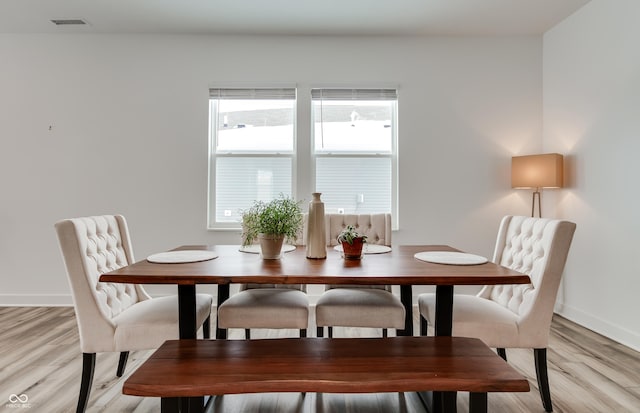 dining room featuring a healthy amount of sunlight and light hardwood / wood-style floors