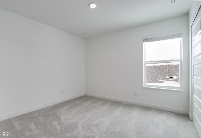 empty room featuring light carpet