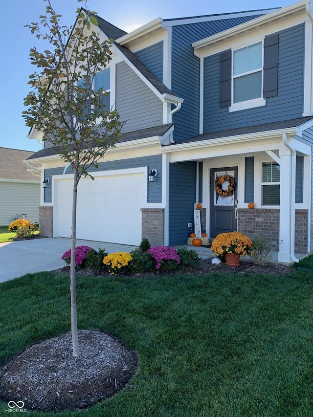 view of front of house with a garage, a front yard, and covered porch