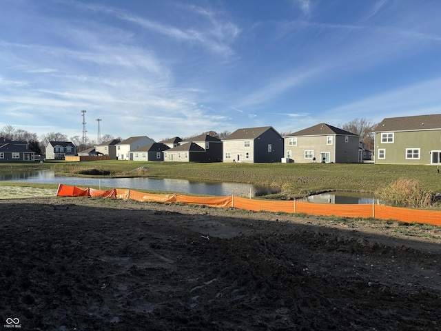 view of yard with a water view and a residential view