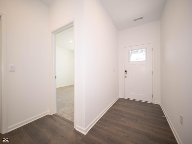 interior space featuring dark wood-style floors, visible vents, and baseboards