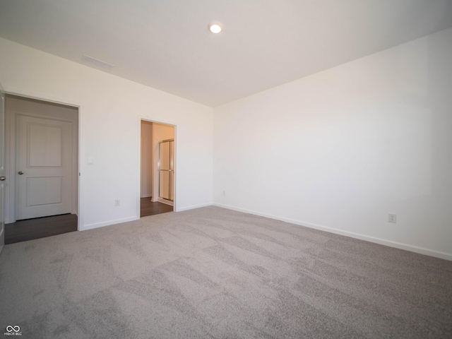 unfurnished room with carpet flooring and baseboards