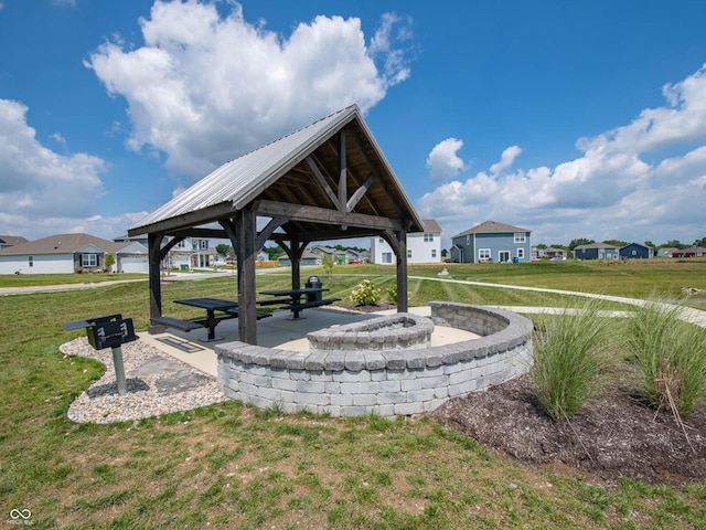 surrounding community with a gazebo and a yard