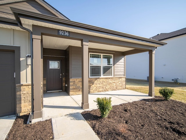 property entrance featuring stone siding and a porch