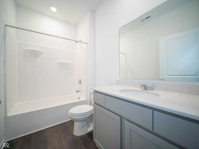 full bath featuring vanity, wood finished floors, visible vents, shower / washtub combination, and toilet