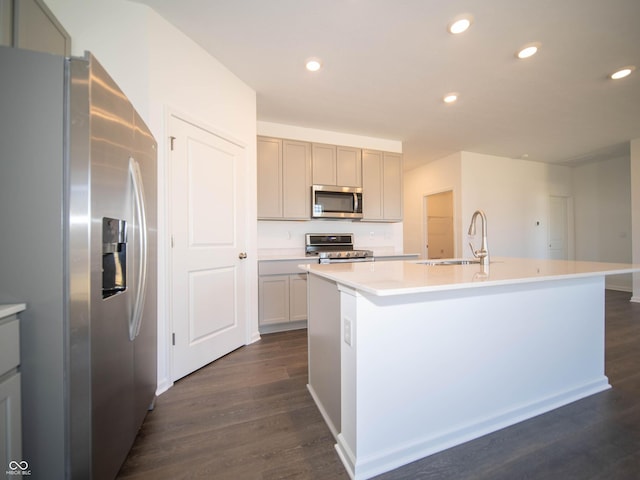 kitchen with a sink, stainless steel appliances, recessed lighting, and dark wood-style flooring