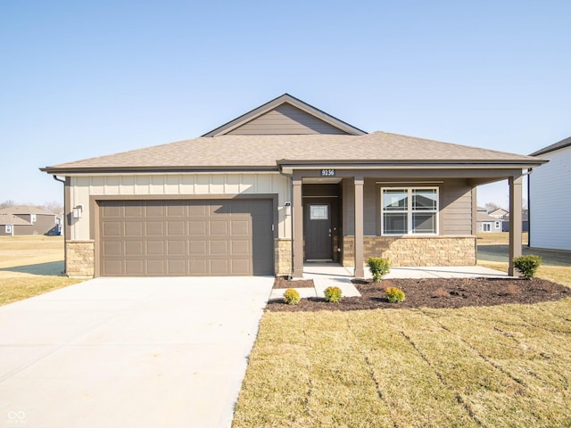 view of front of home featuring stone siding, board and batten siding, and a garage