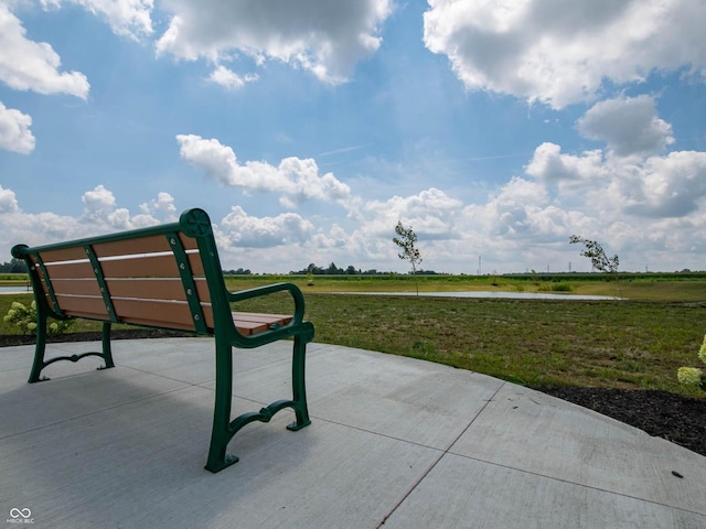 view of home's community featuring a rural view and a lawn