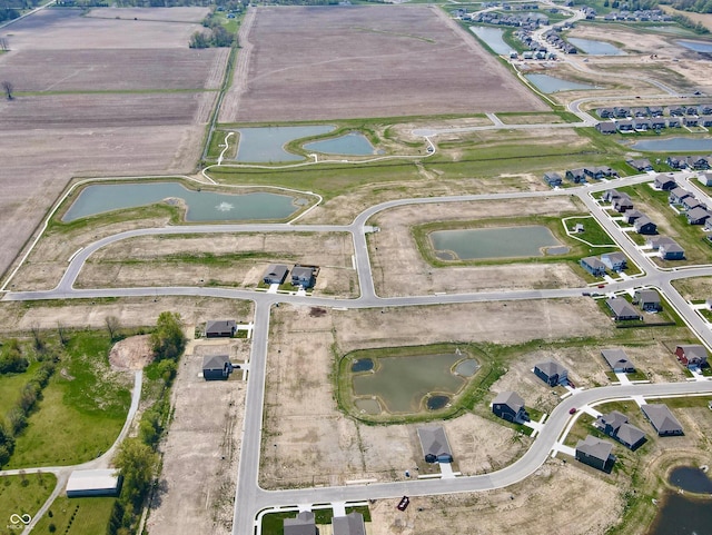 aerial view with a rural view and a water view