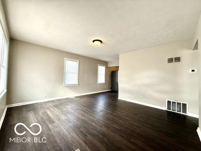 empty room featuring dark wood-type flooring