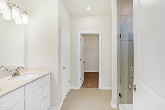 bathroom with tile patterned flooring, an enclosed shower, and vanity