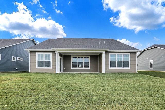 rear view of house with a lawn