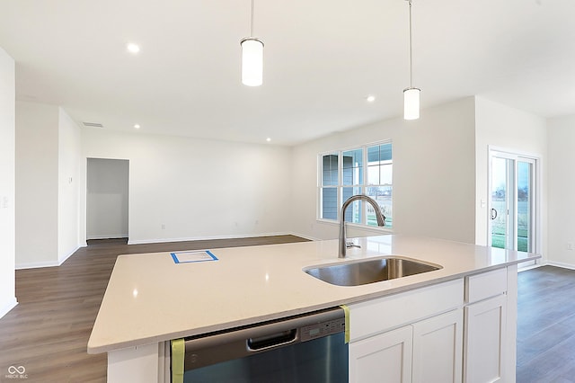 kitchen with stainless steel dishwasher, hanging light fixtures, sink, white cabinets, and a kitchen island with sink