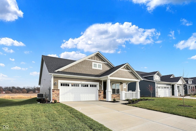 craftsman house featuring covered porch, a garage, and a front lawn