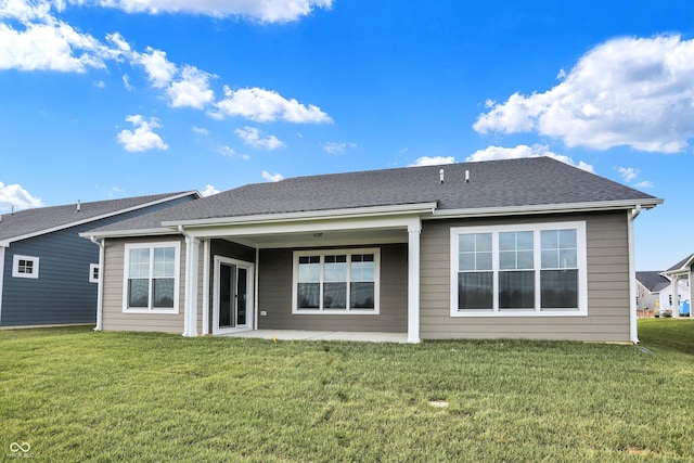 back of house with a lawn and a patio