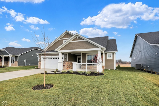 craftsman-style house featuring a front yard, a porch, and a garage