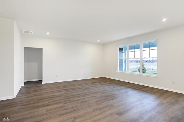 unfurnished room with dark hardwood / wood-style floors