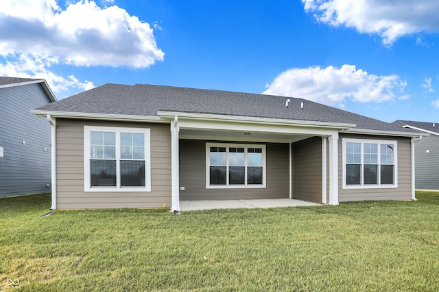 rear view of property with a lawn and a patio