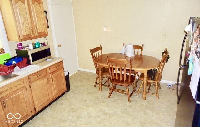 dining room featuring light colored carpet