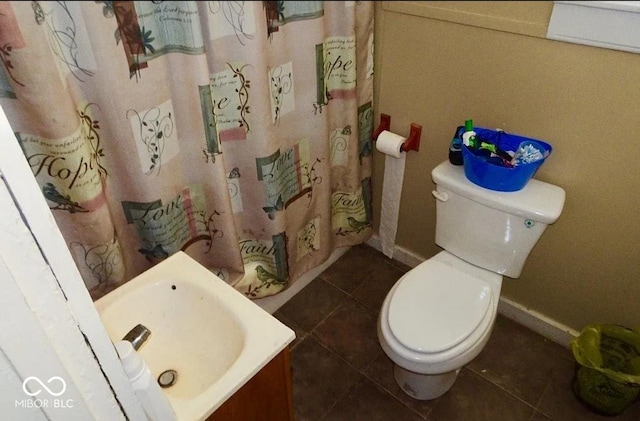 bathroom with sink, toilet, and tile patterned floors