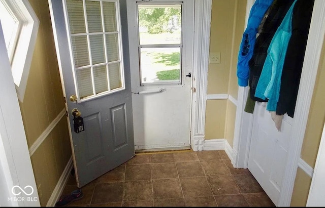 entryway featuring dark tile patterned flooring