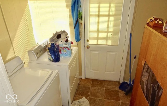 laundry area with washing machine and clothes dryer and plenty of natural light