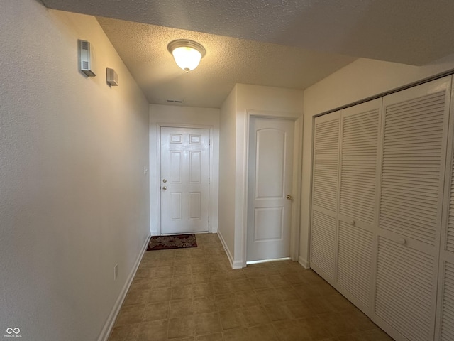 corridor with a textured ceiling