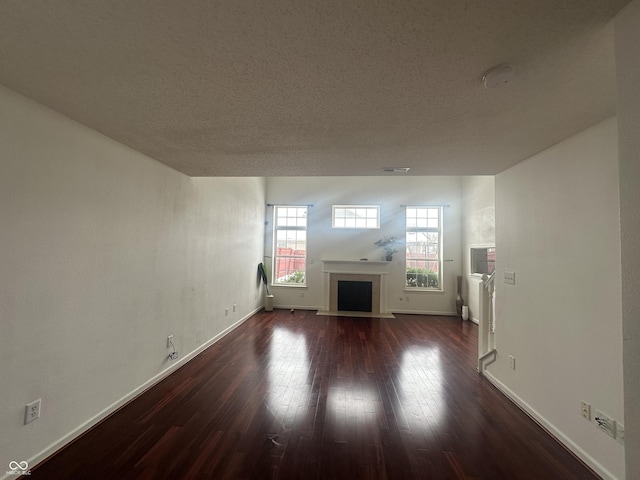 unfurnished living room featuring dark hardwood / wood-style flooring